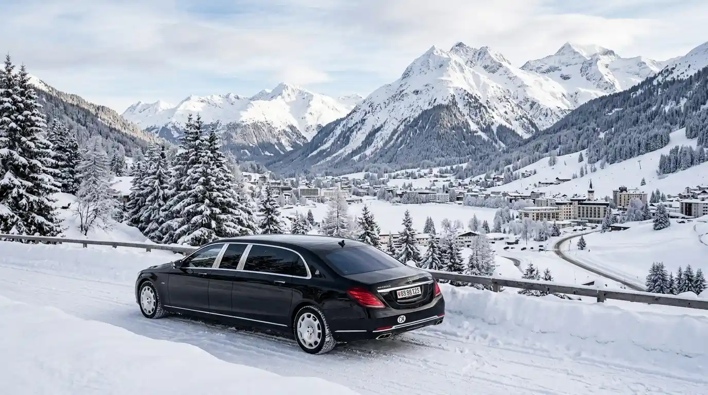 Black luxury Mercedes limousine driving through snow-covered alpine resort in Davos during winter